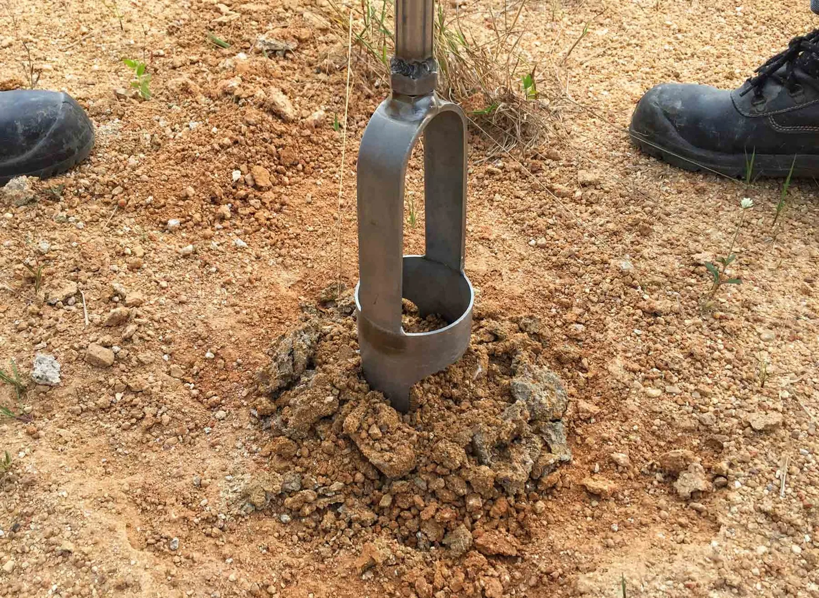Hand auger pulling a soil sample for a perc test