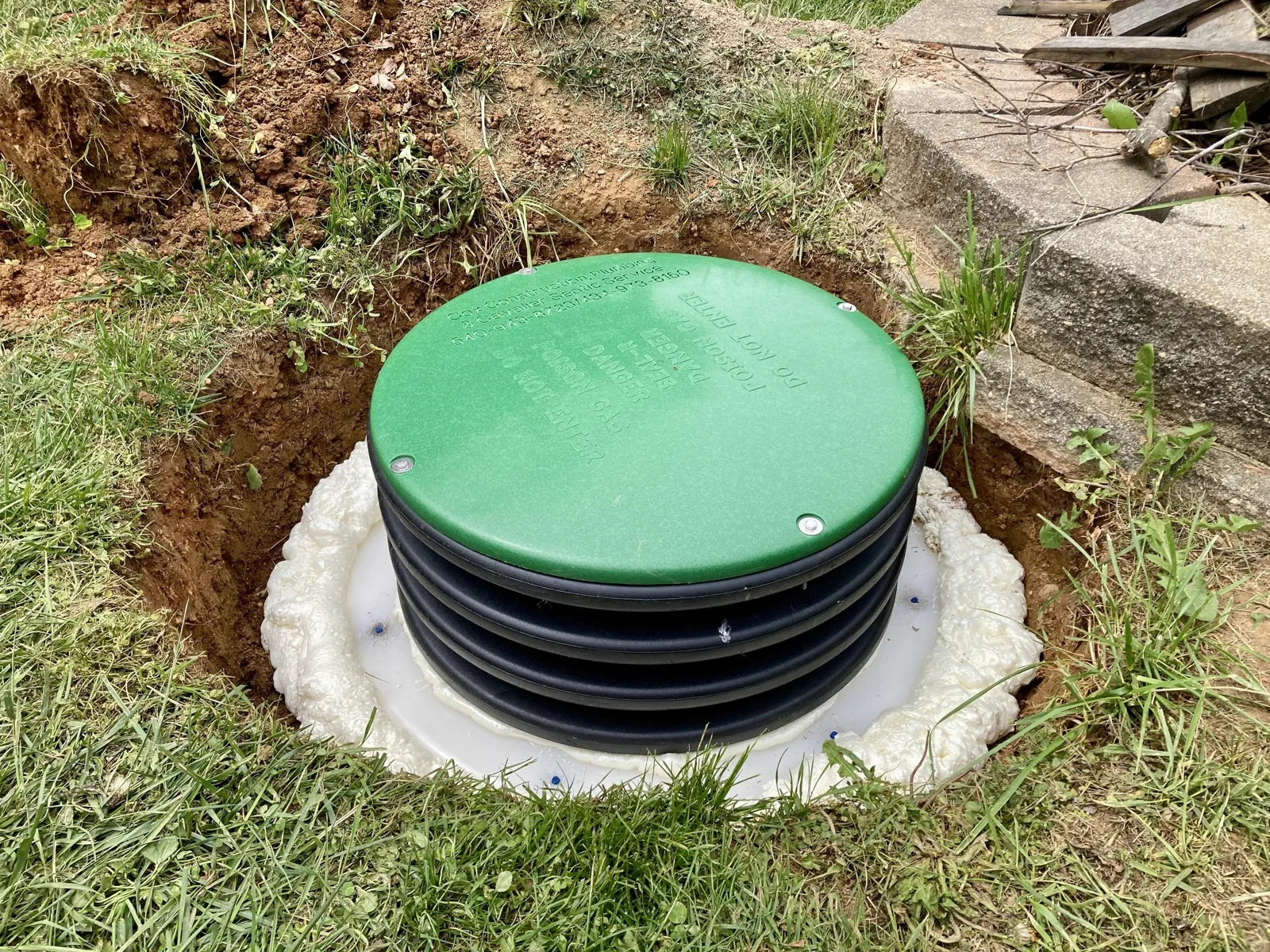 Septic tank riser sealed with foam during a riser installation
